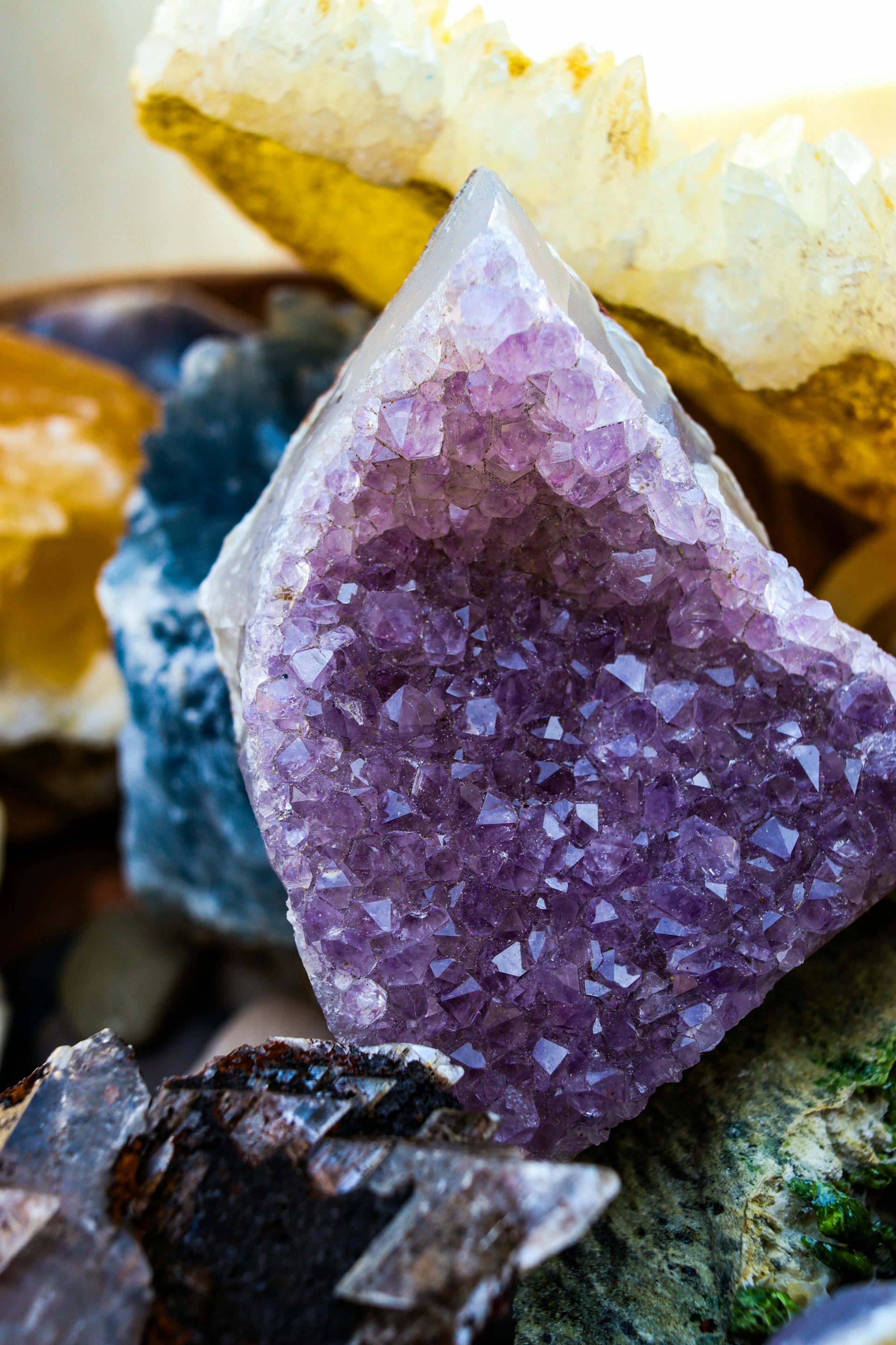 Purple amethyst crystals showcased with other colorful stones.
