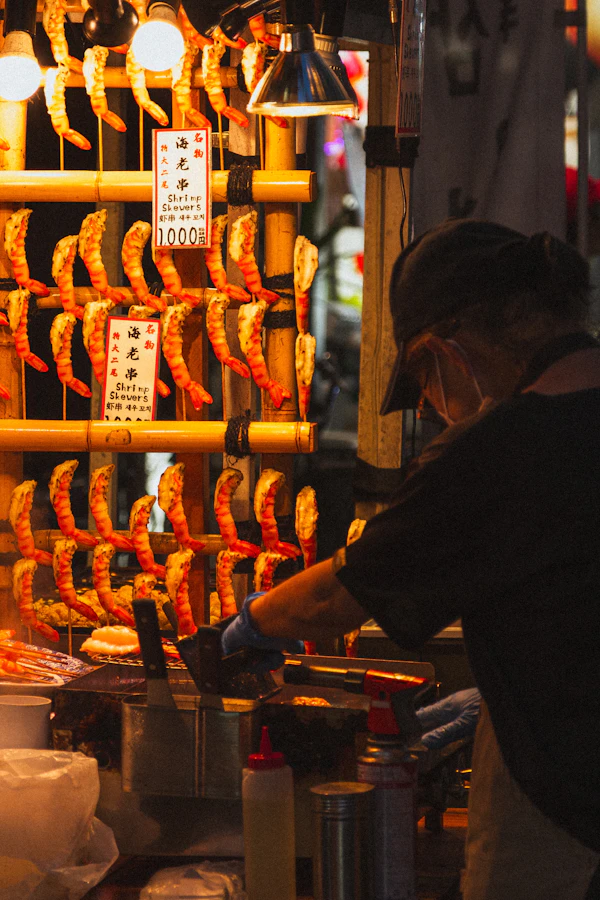 Chef grilling fresh shrimp on hibachi grill