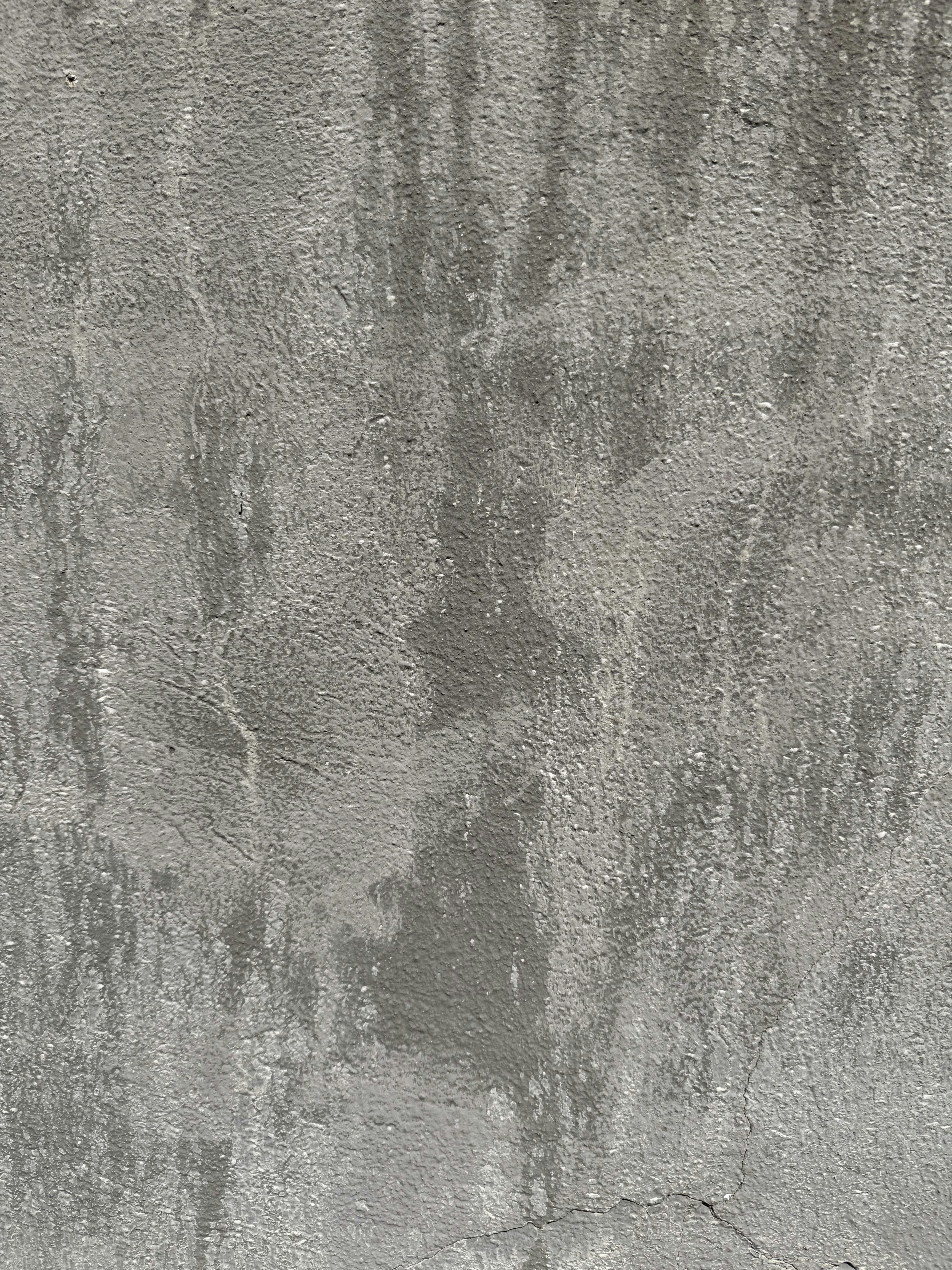 Textured gray wall with water stains.