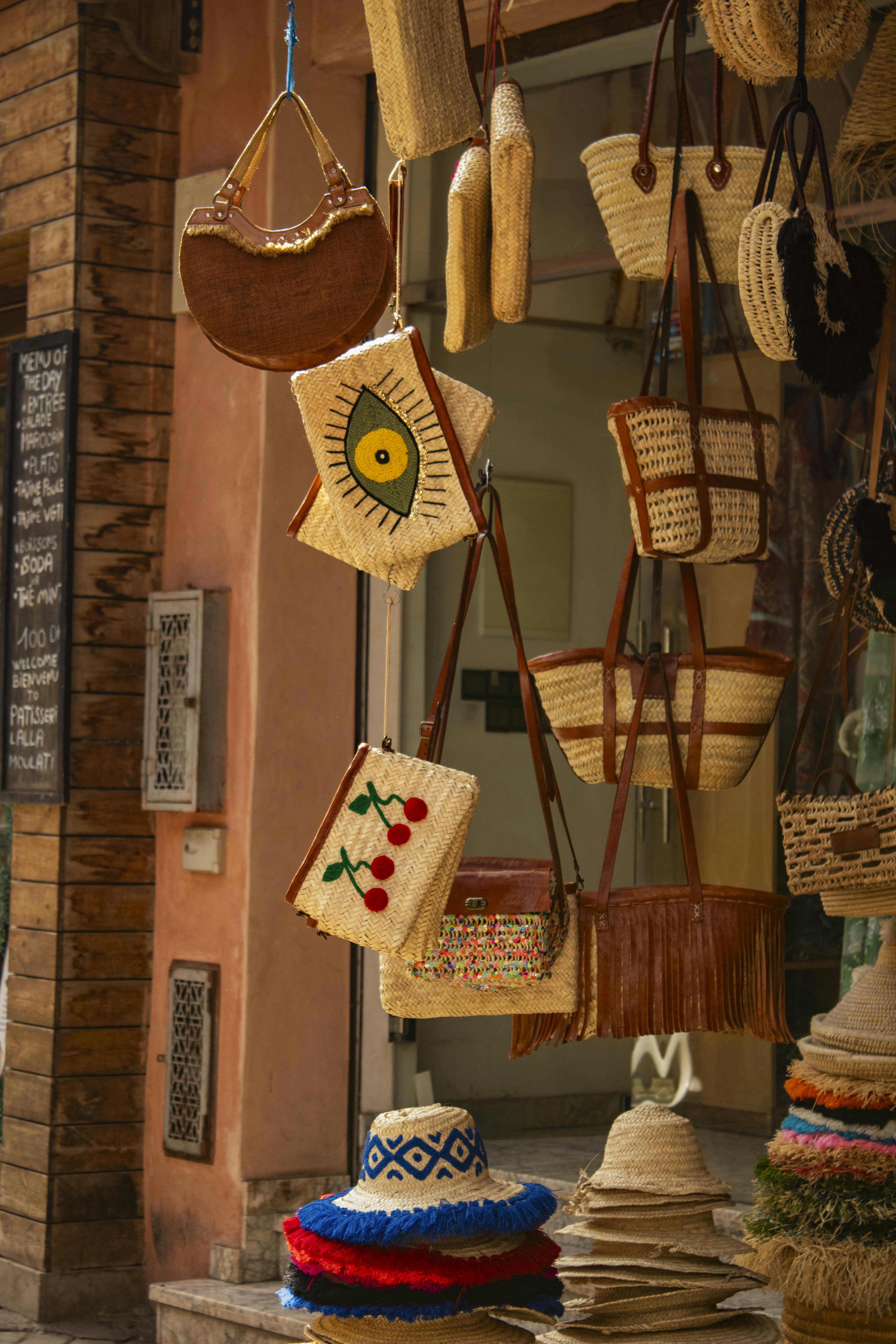 Baskets and bags hang outside a shop.
