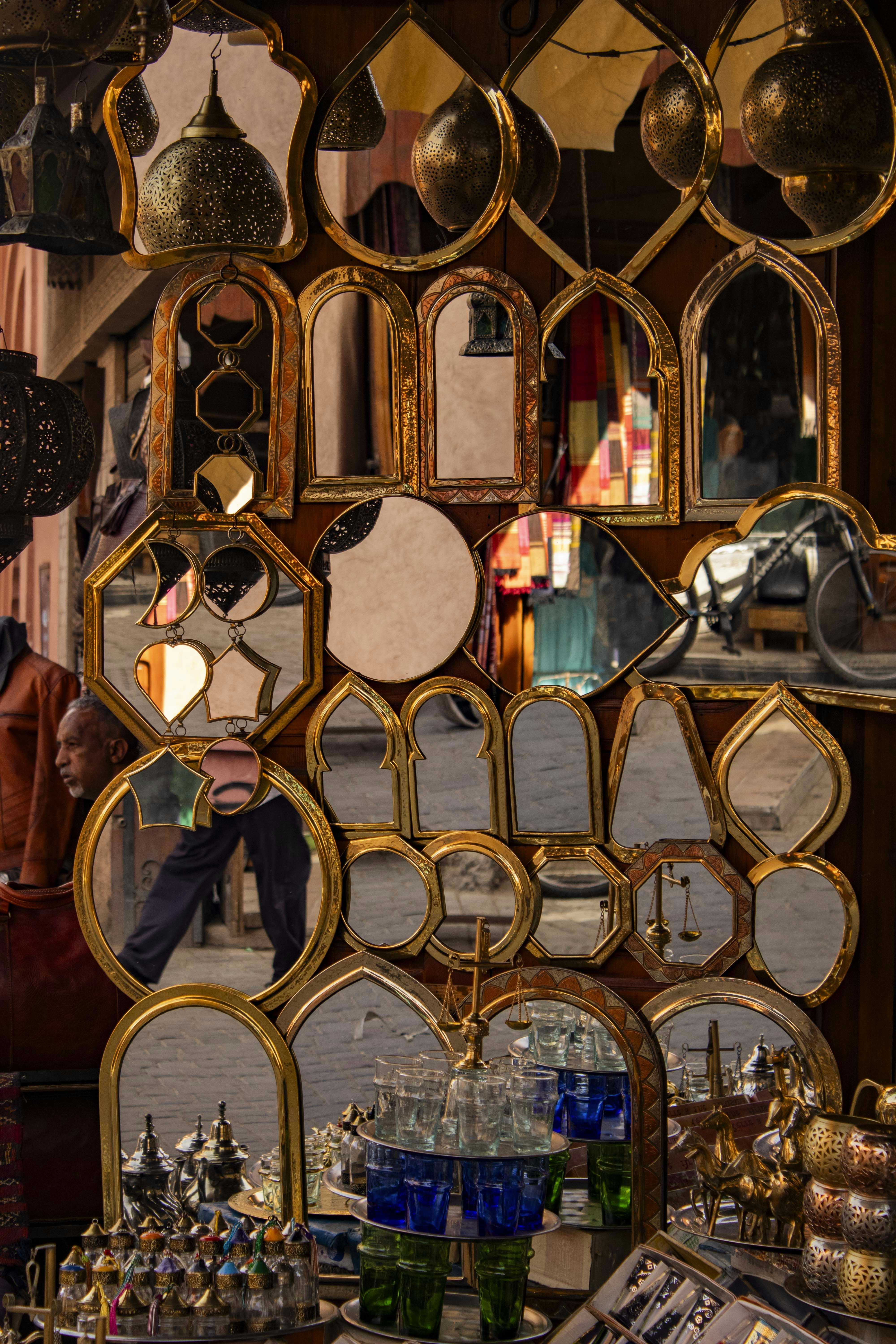 Mirrors and decorative items are displayed in a market.