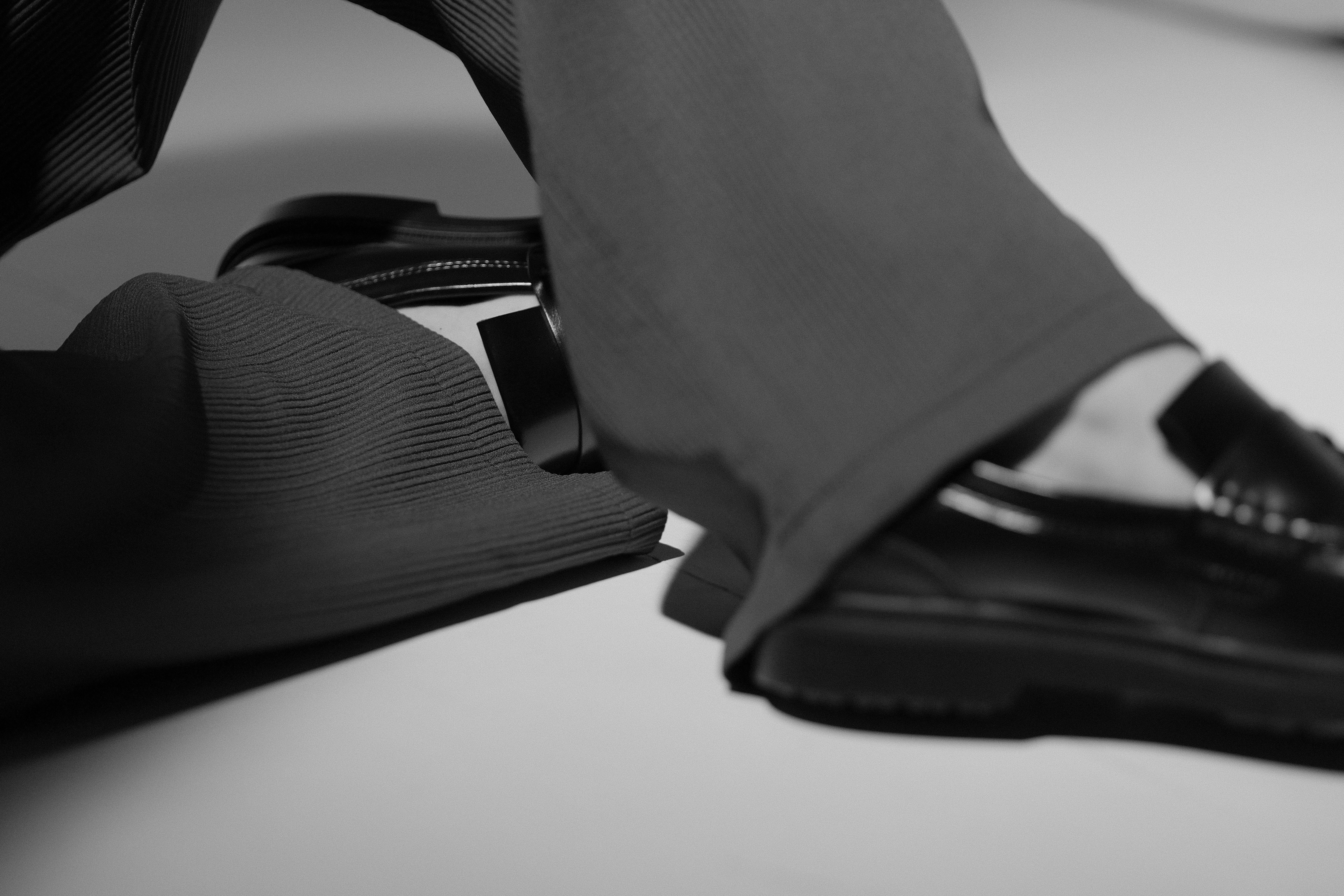 Person wearing loafers and trousers.