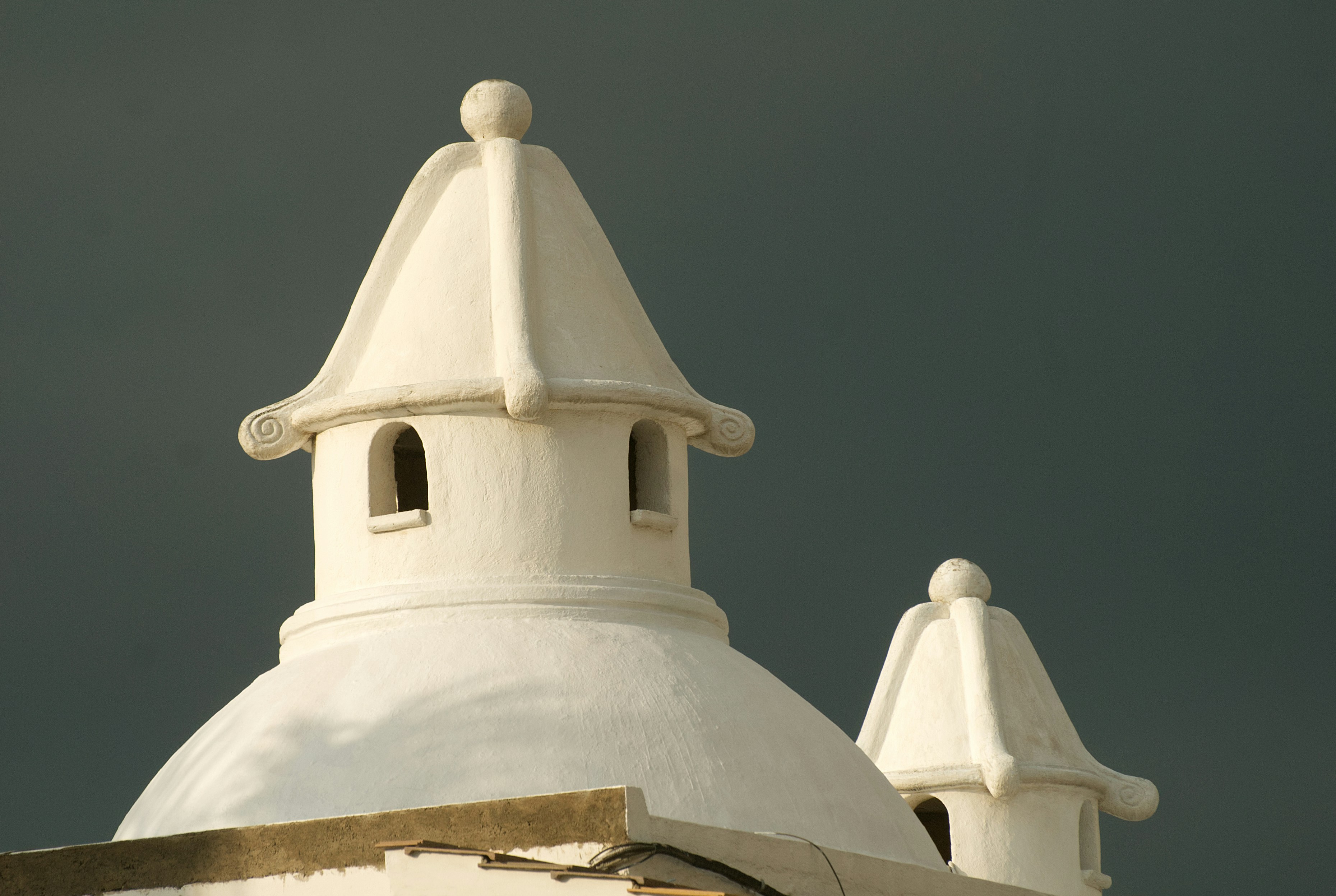 White domed structures against a dark sky.
