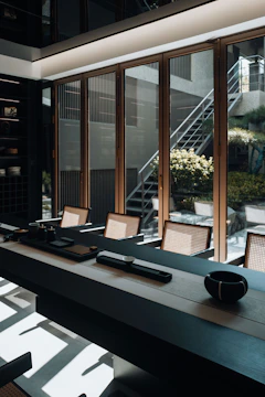 Elegant room with a long table and window view.