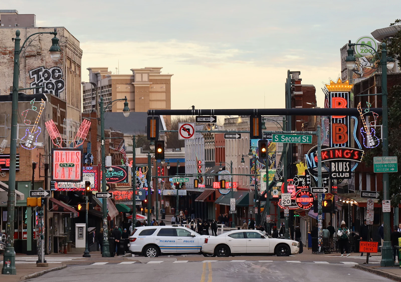 A street of neon signs after dark.
