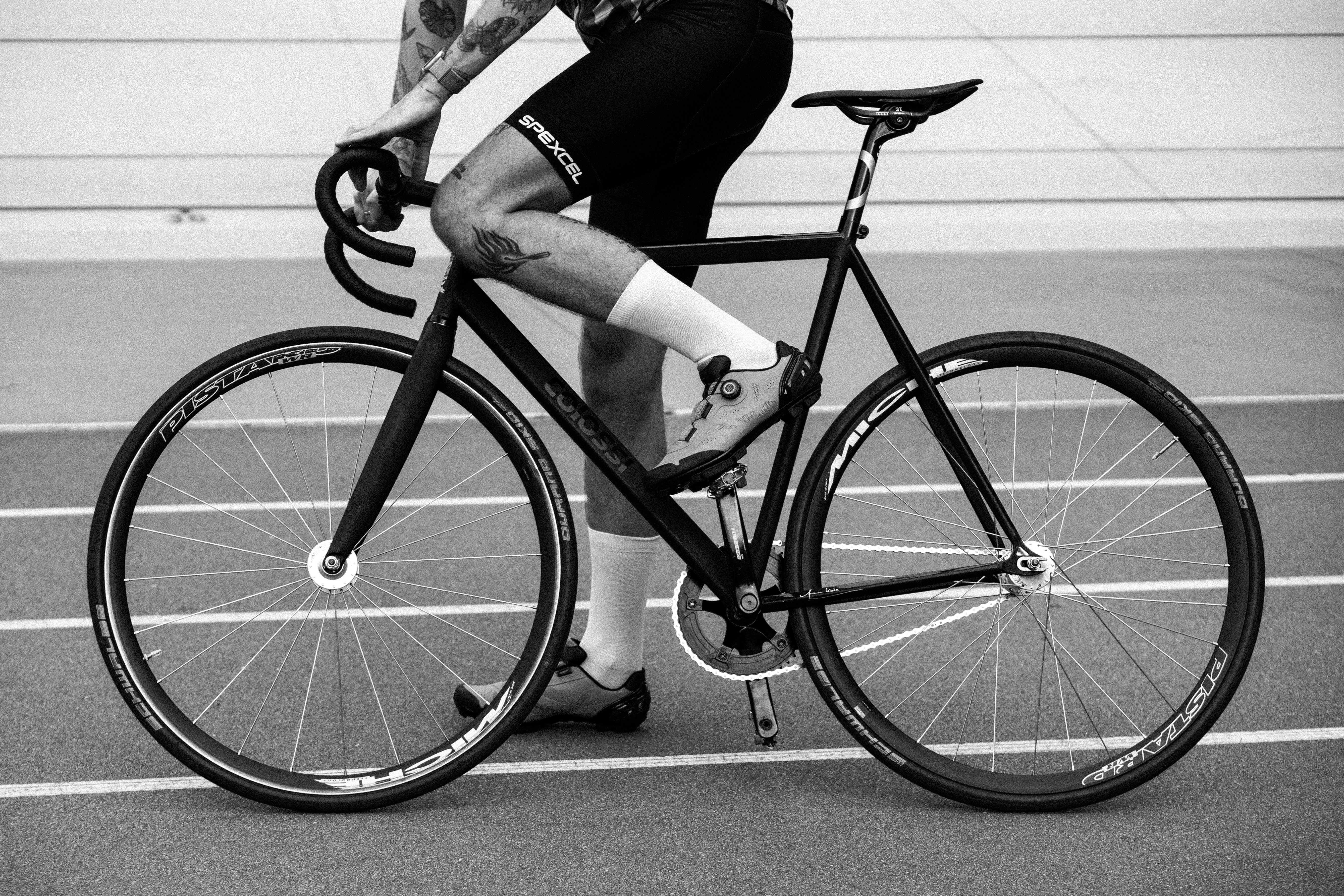 Cyclist riding a fixed-gear bike on a track