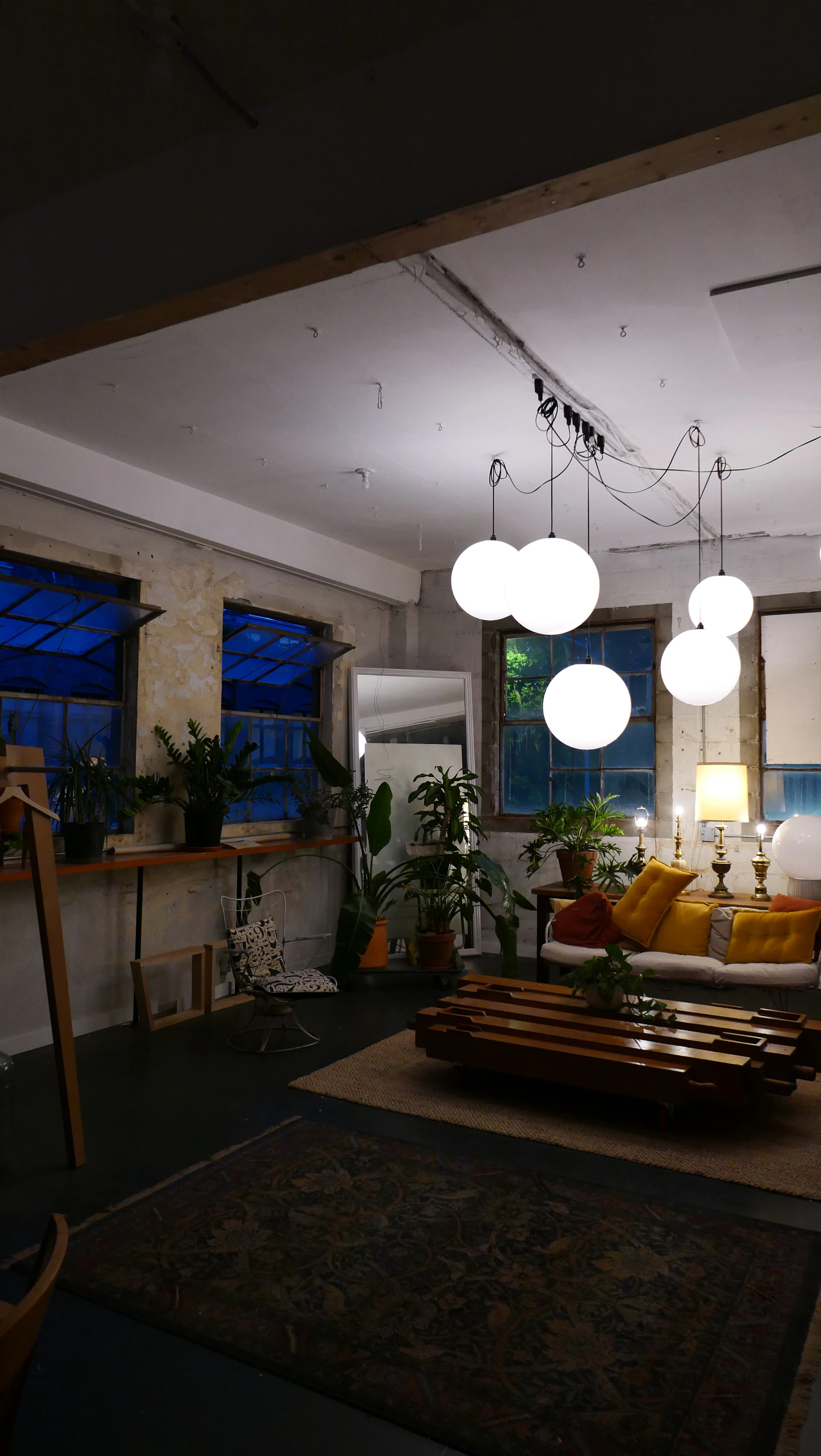 Cozy room with plants, furniture, and orb lighting.