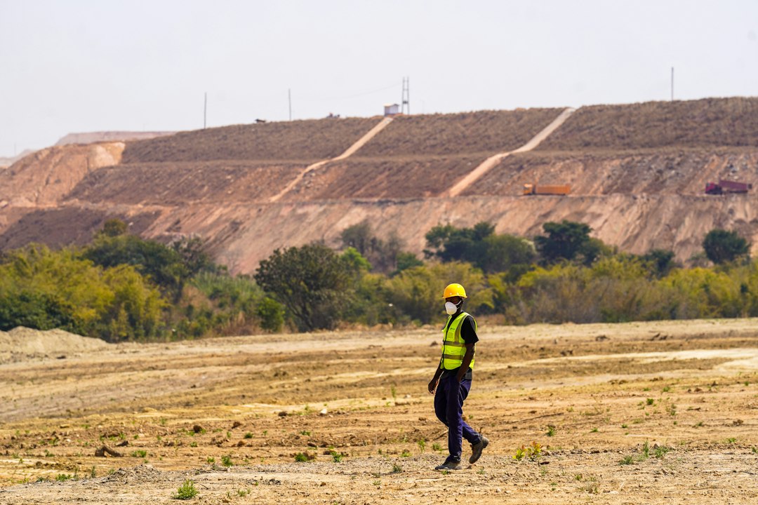 A worker walks near a construction site.