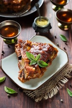 Deliciously cooked meat served with drinks and sauce.