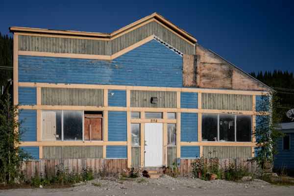 A weathered gold-rush building under a blue sky — Dawson City, Canada