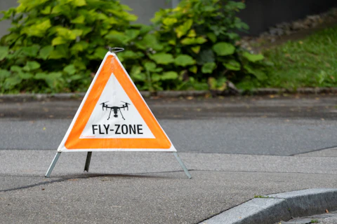 Drone fly zone sign on the ground.