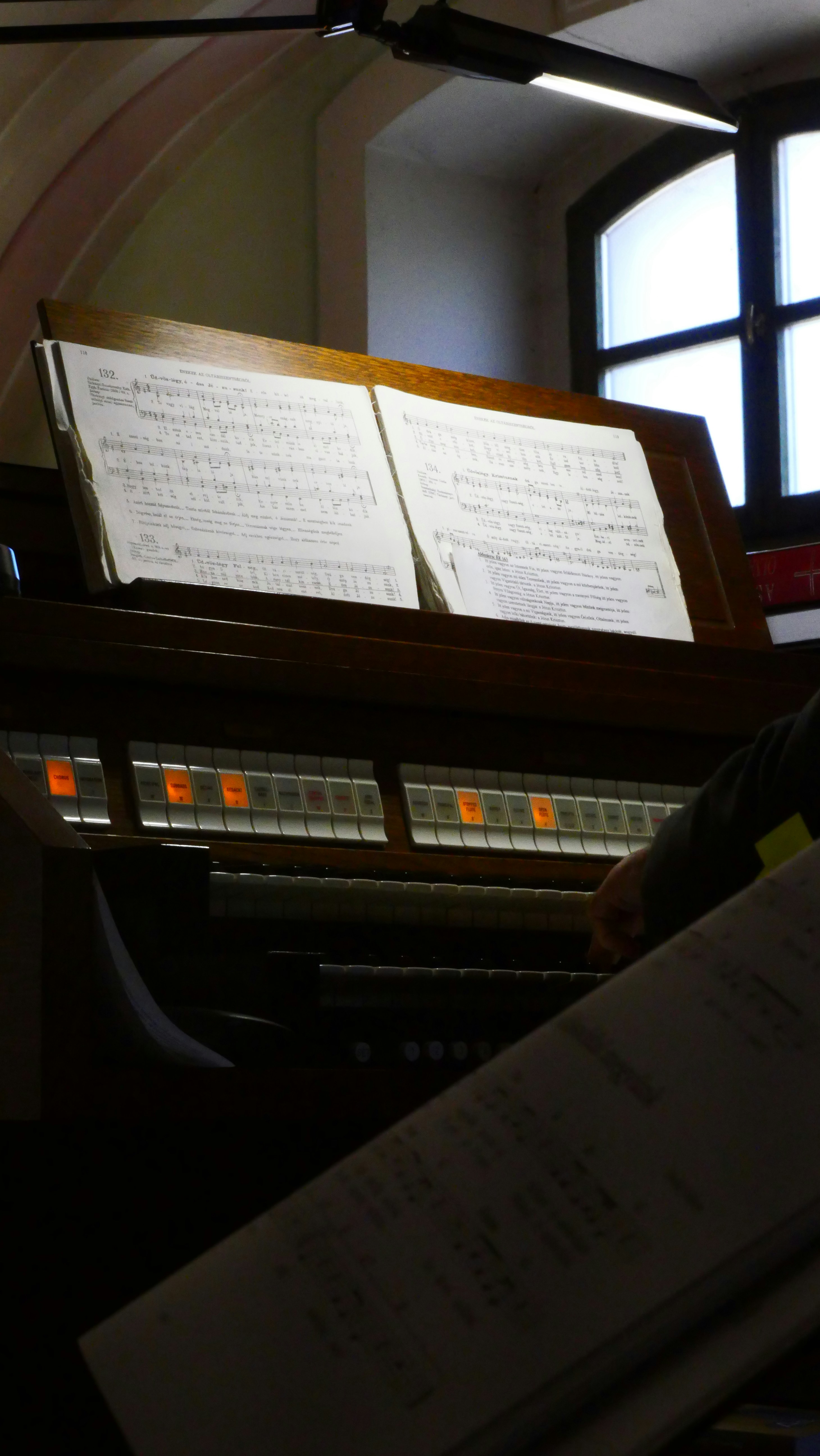 An organist playing a vintage pipe organ.