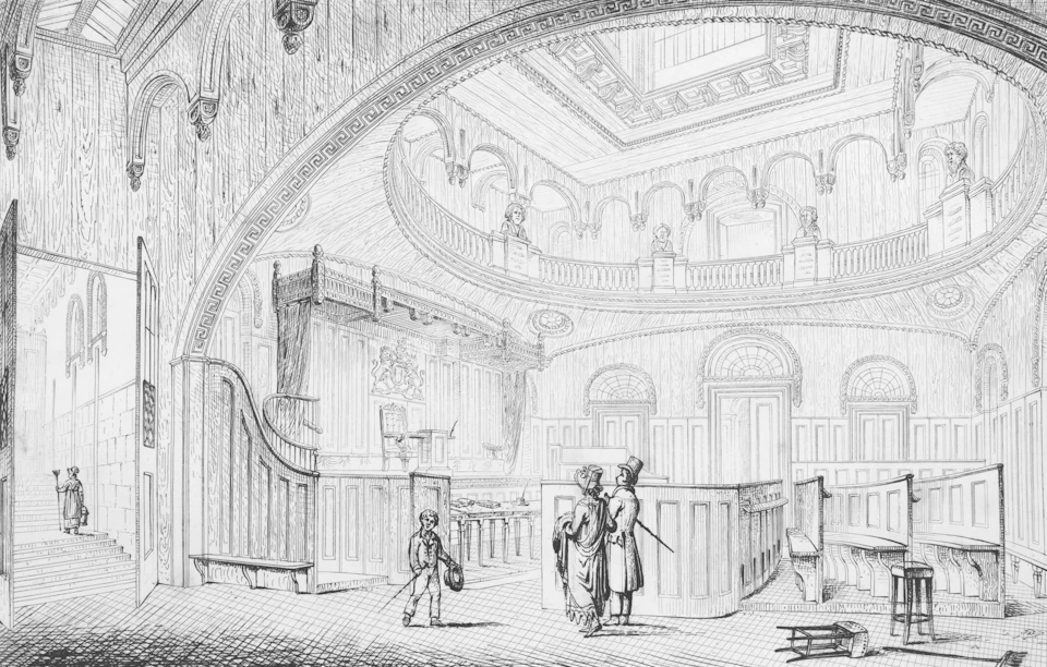 Lively crowd gathers around large wooden stage with performer holding book and instrument