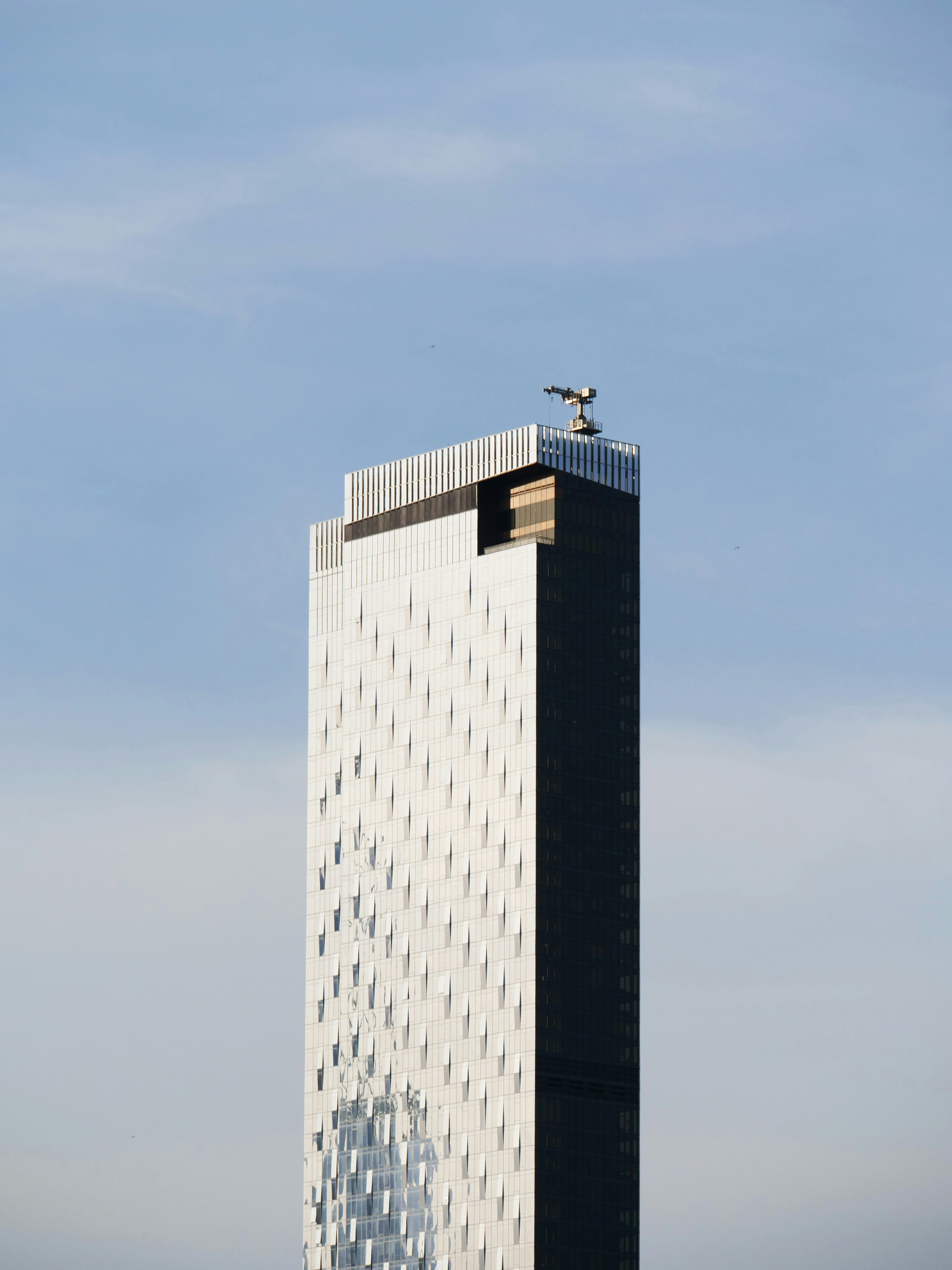 A modern skyscraper reaches towards the sky.