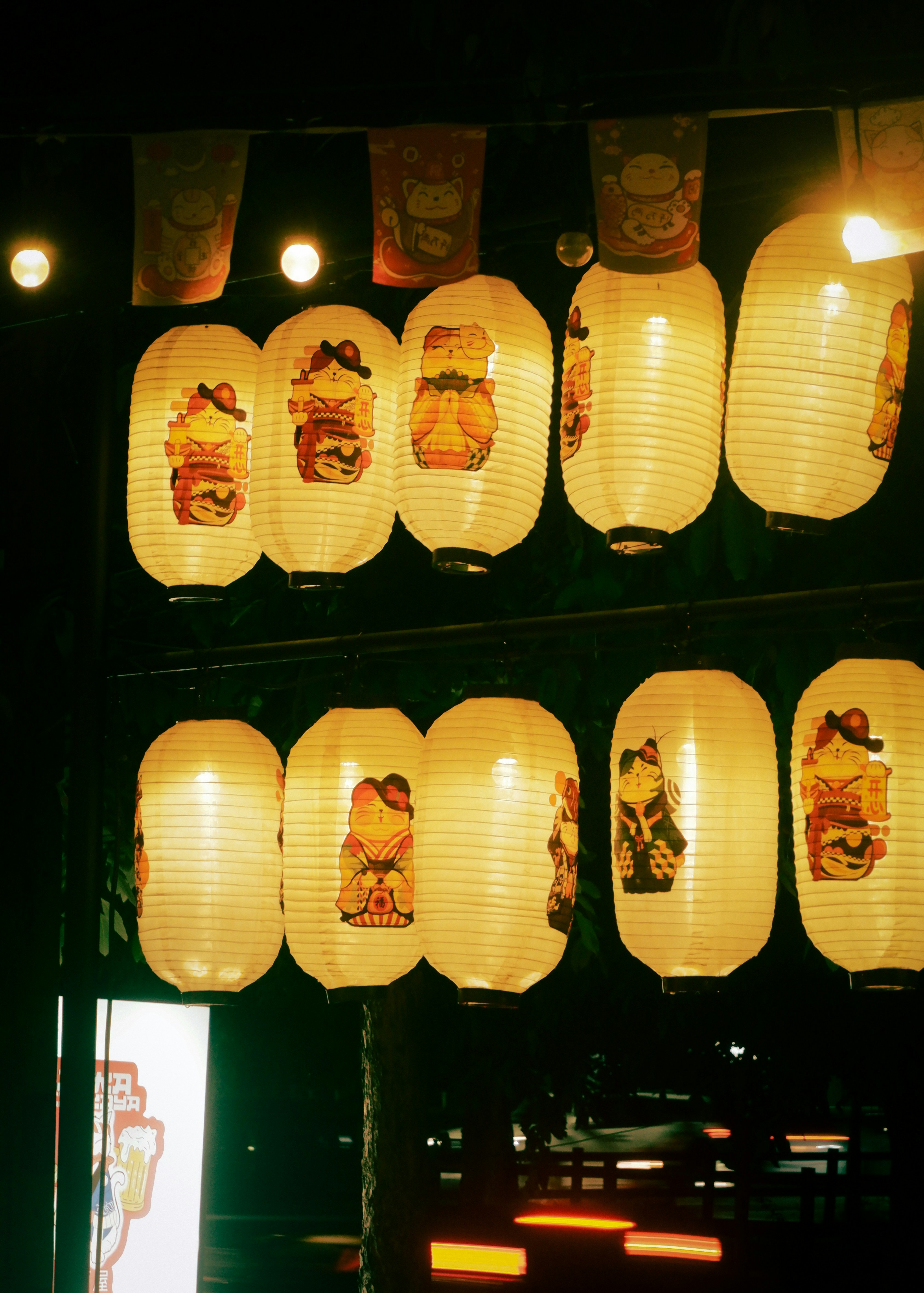 Glowing japanese lanterns illuminate the night.