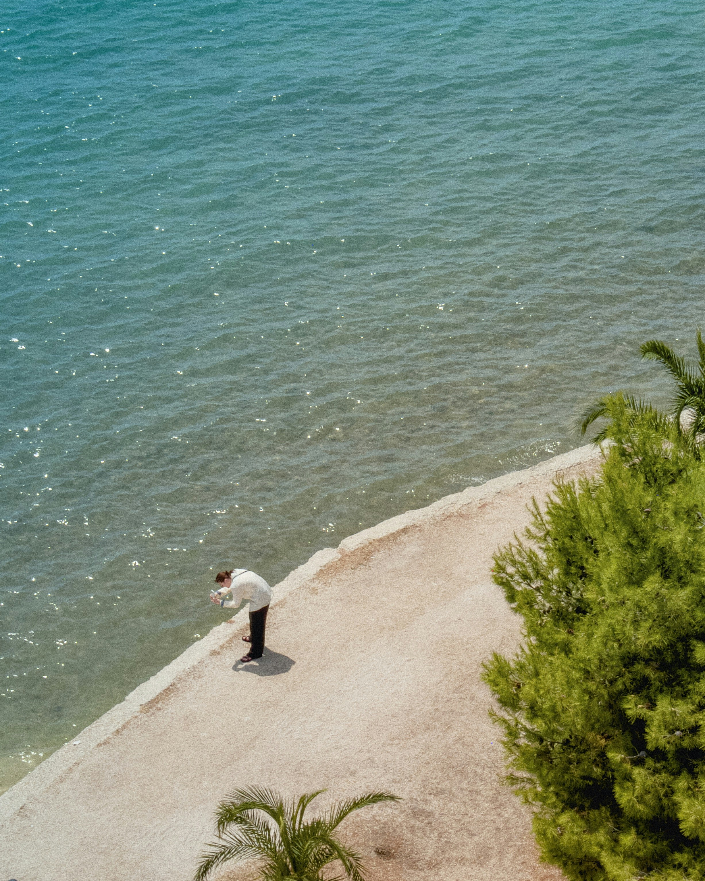 A man stands near the ocean.
