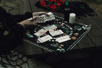 Someone is reading tarot cards outdoors.