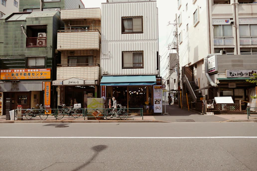 Shops and buildings line a street in a city