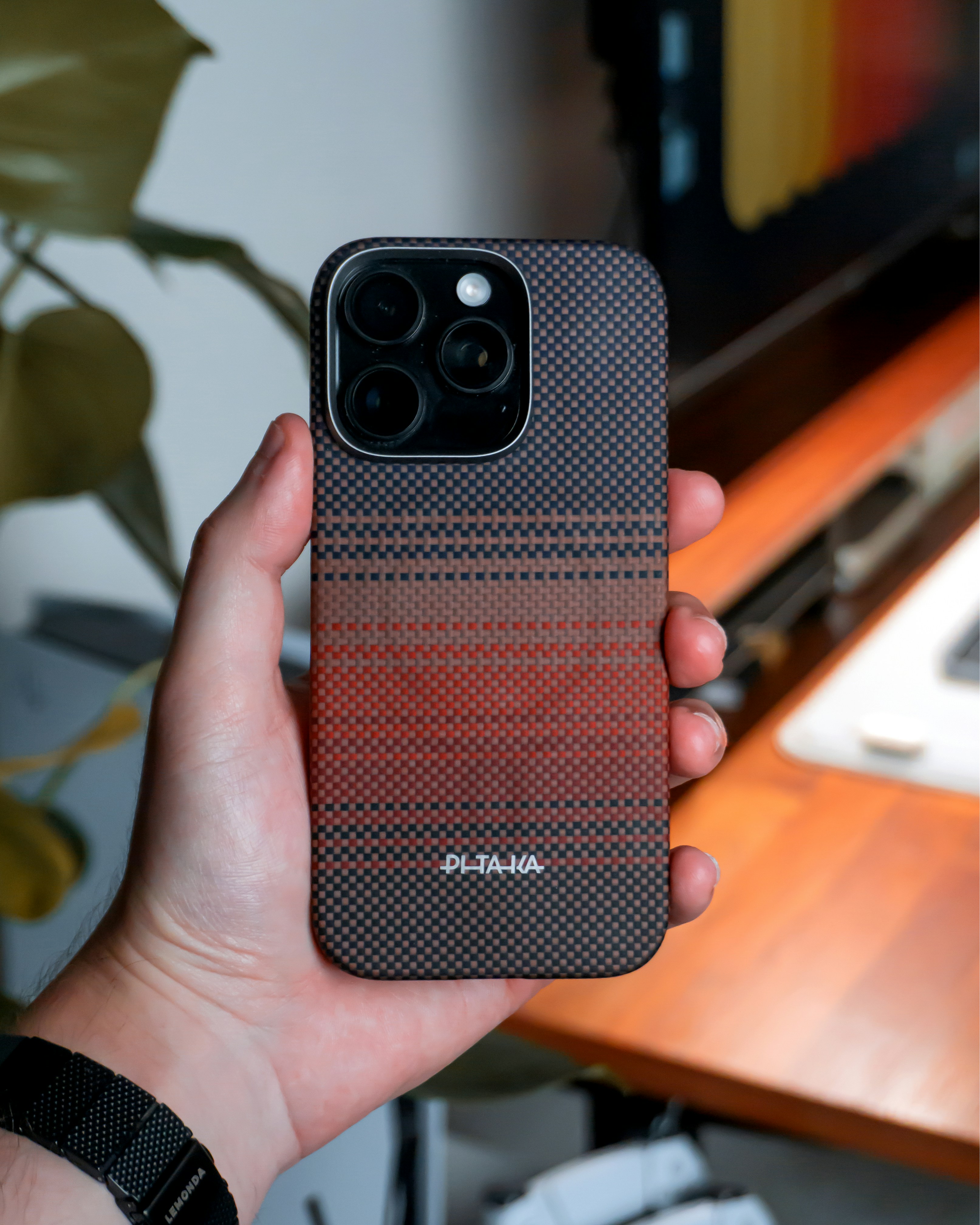 A person holds a phone with a unique case.
