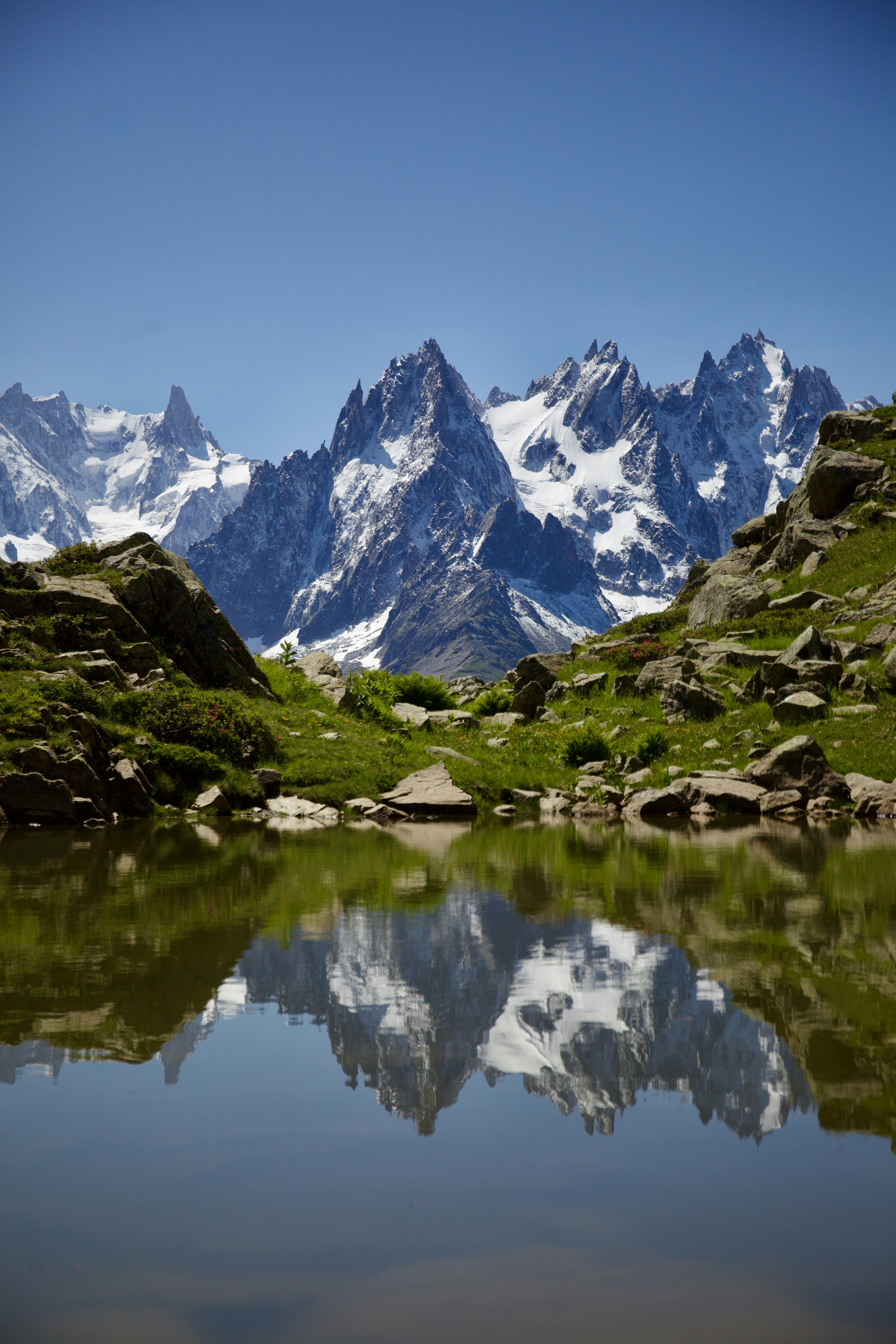 Mountains reflected in the still, clear water.