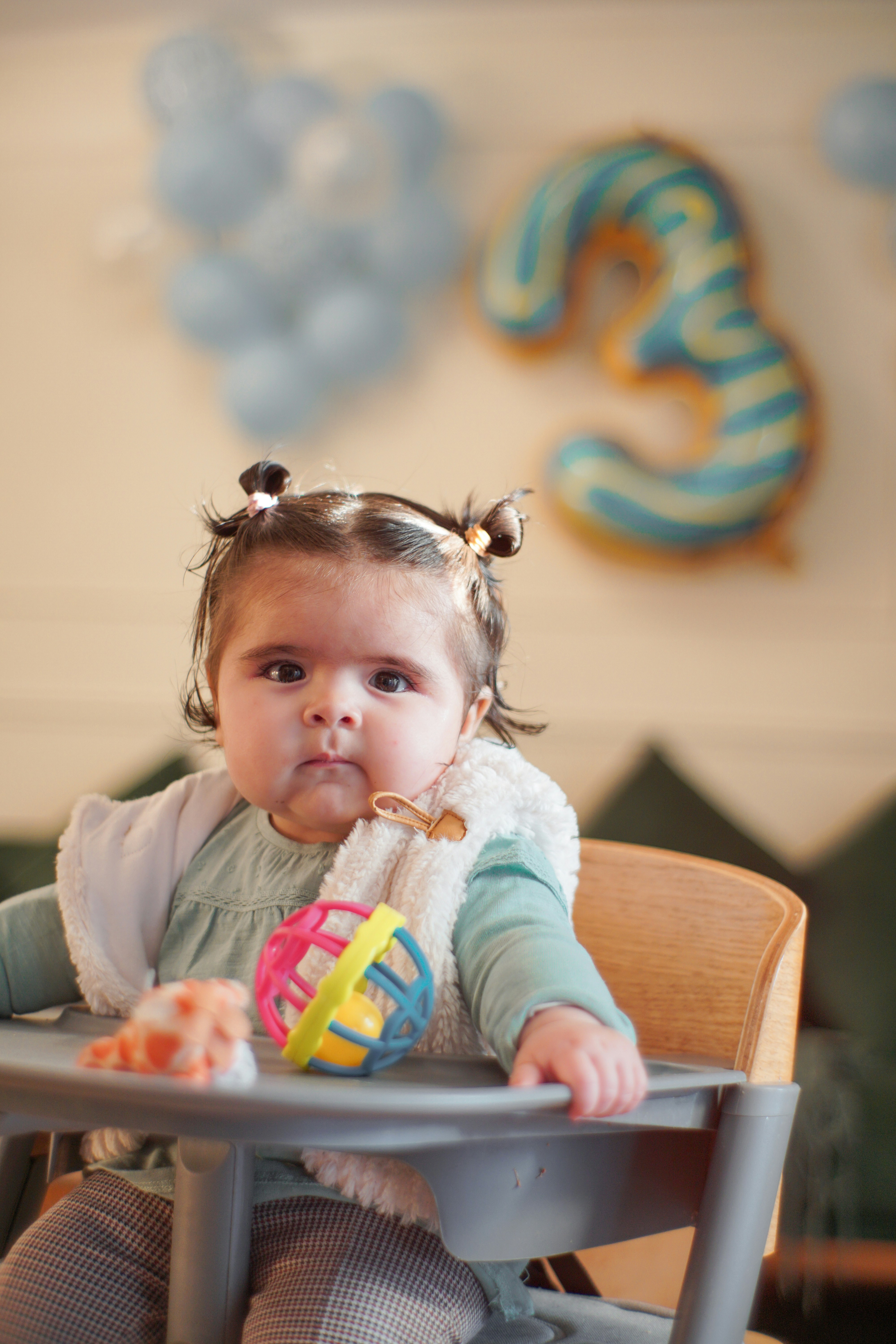 Baby girl looks at the camera during her third birthday.
