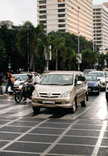 Vehicles drive on a busy city street.
