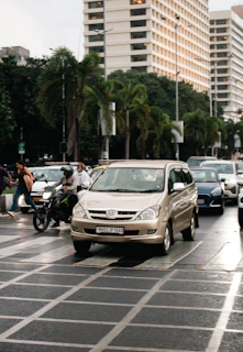 Vehicles drive on a busy city street.