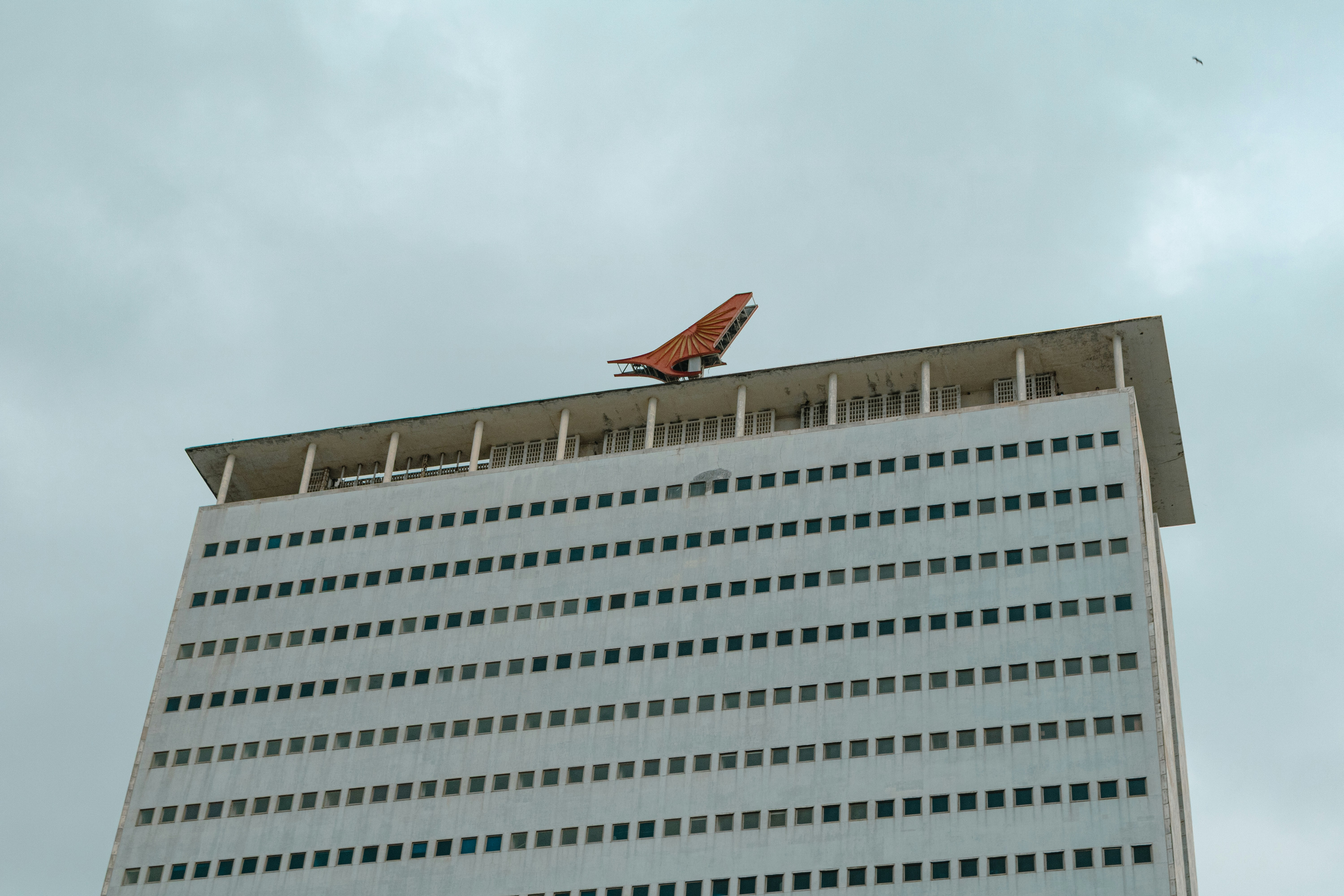 A model airplane sits atop a high-rise.