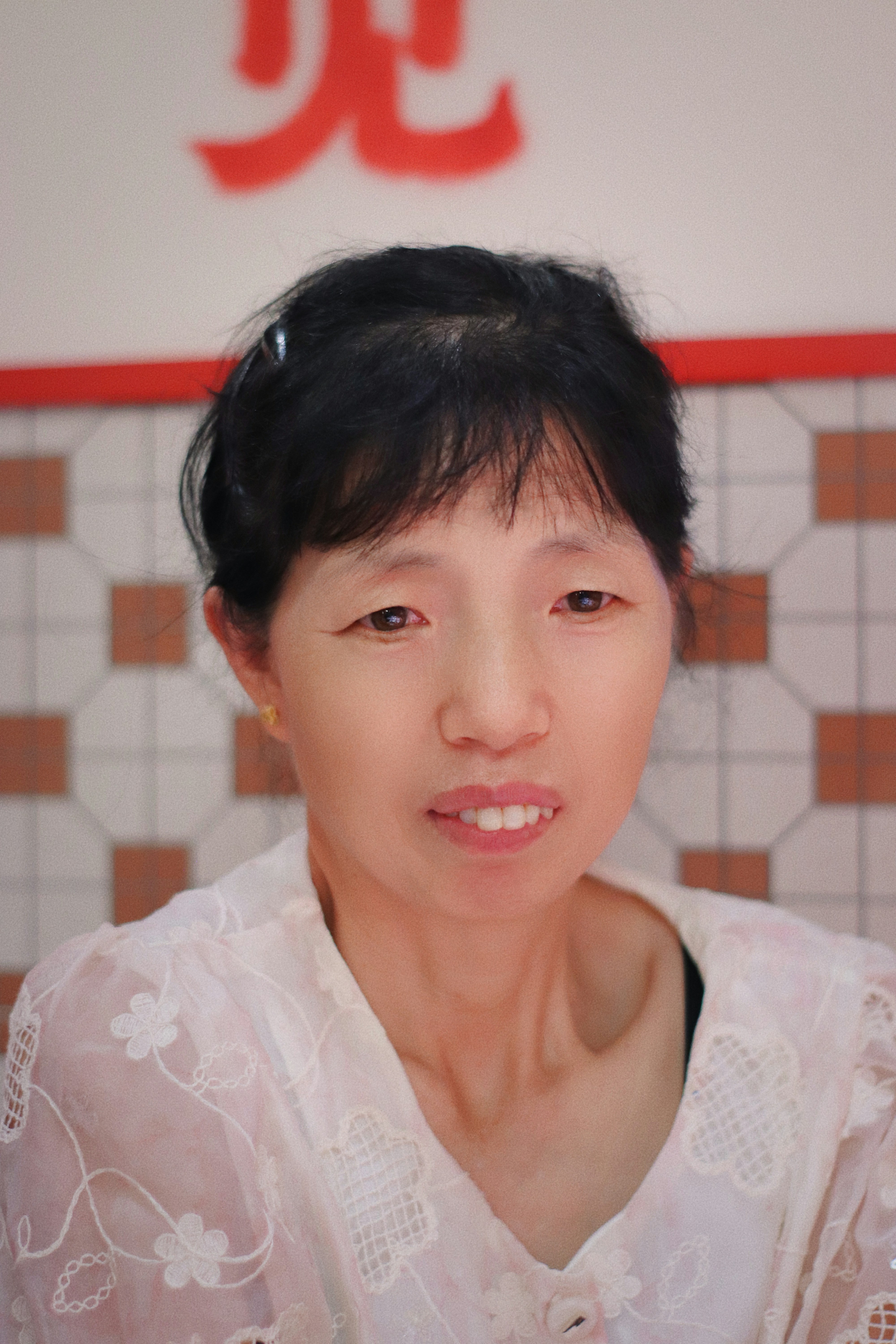 A woman is looking directly at the camera.