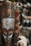 An intricate, carved wooden african mask is shown.