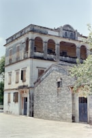 An old, multi-story building is seen.