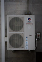 An air conditioning unit is mounted on a wall.