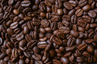 Roasted coffee beans fill the frame.