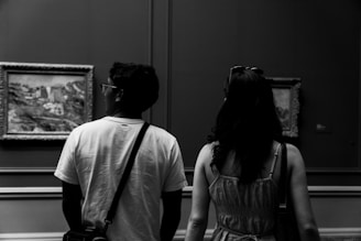 Couple admires artwork in a museum.
