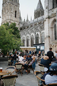 People relax outside a cathedral.