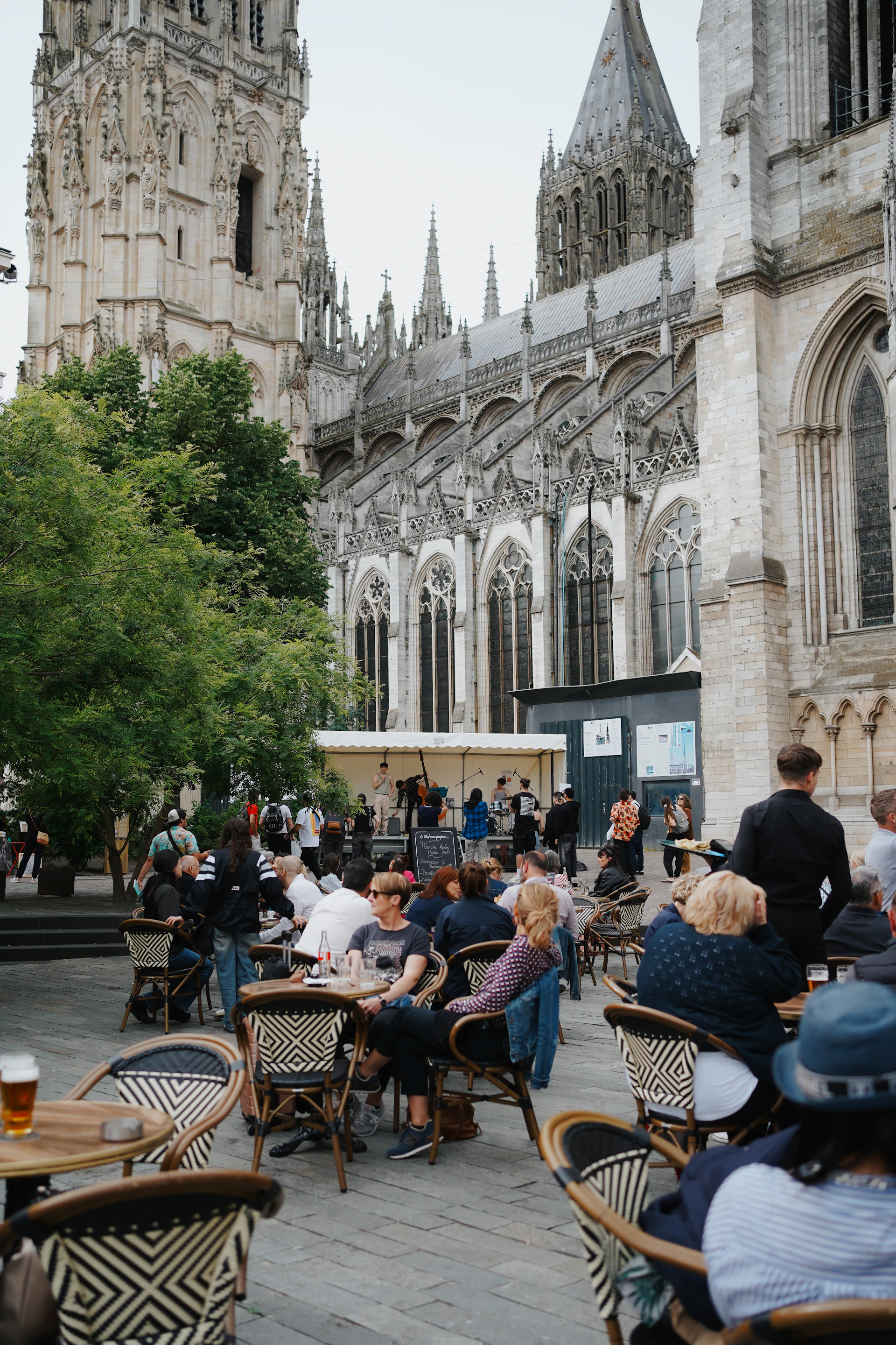 People relax outside a cathedral.