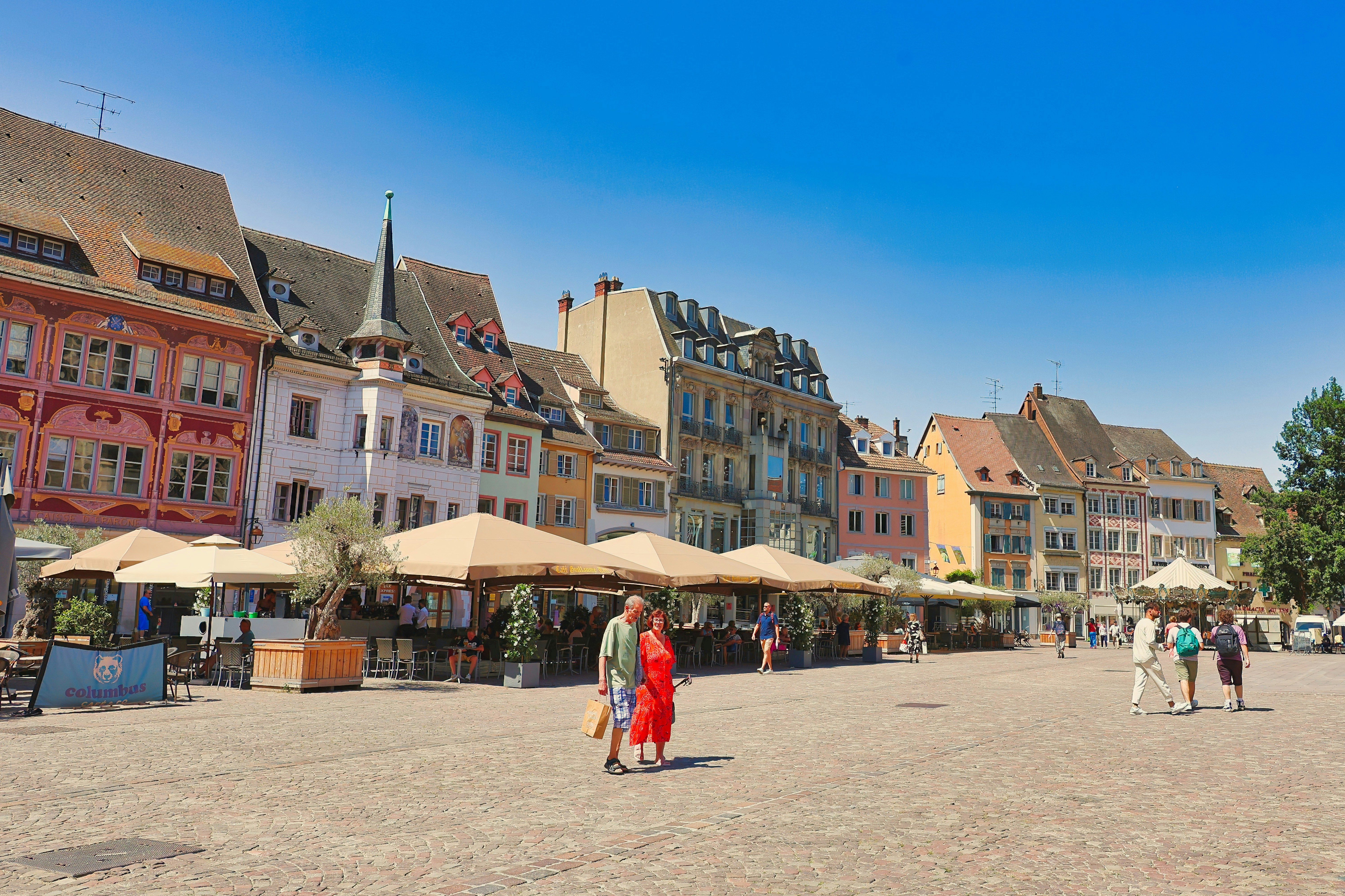 Colorful buildings and a plaza on a sunny day.
