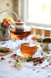 A beautiful teacup and teapot, ready for tea.