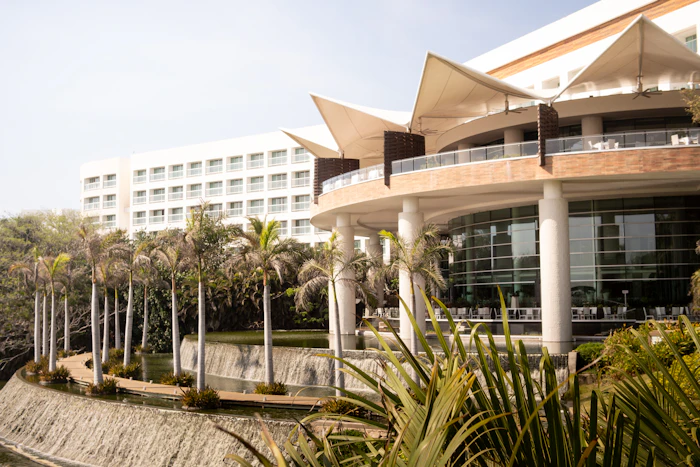 A resort hotel building with palm trees