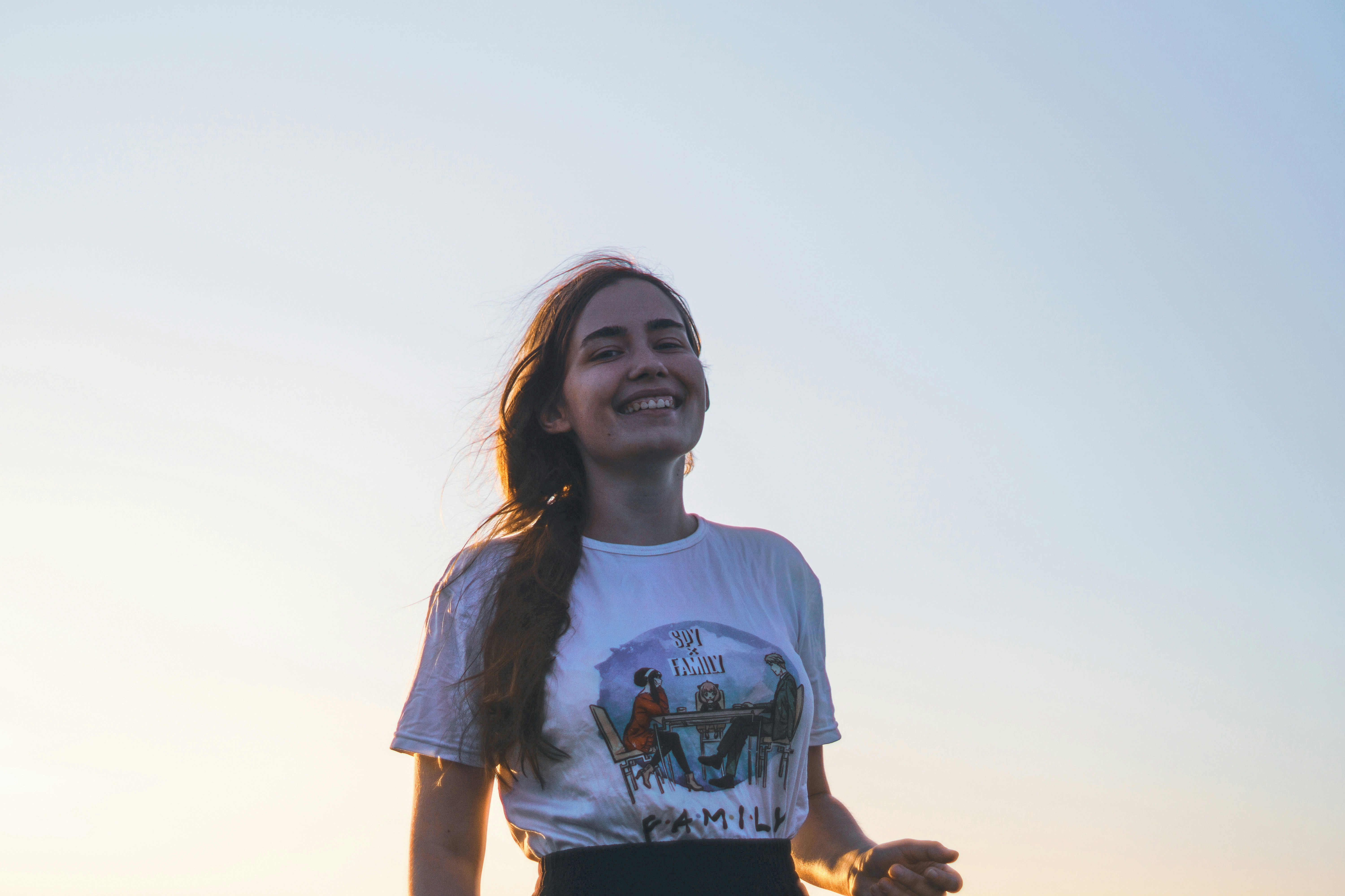 Happy woman smiling under a clear sky