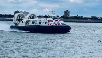A hovercraft with a british flag is cruising.