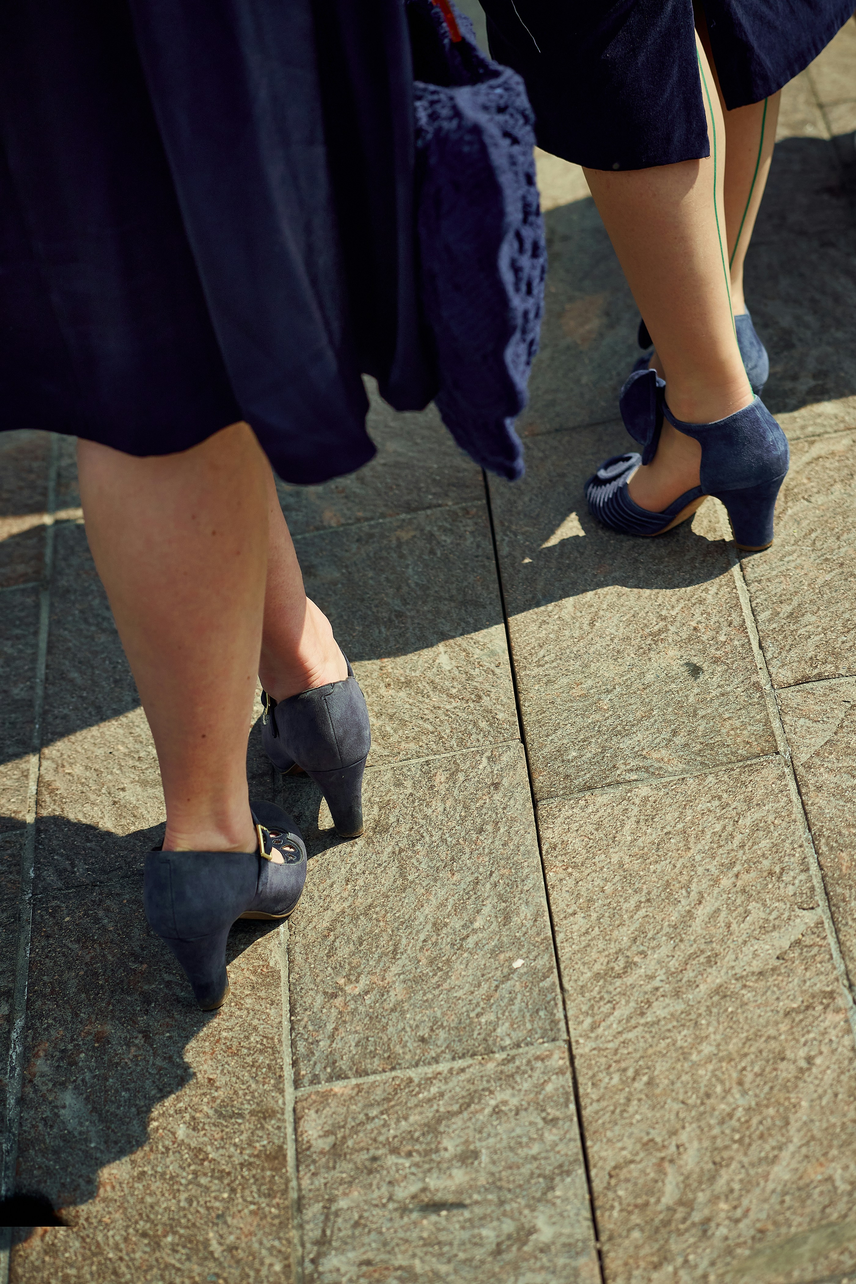 People in blue dresses and matching shoes.