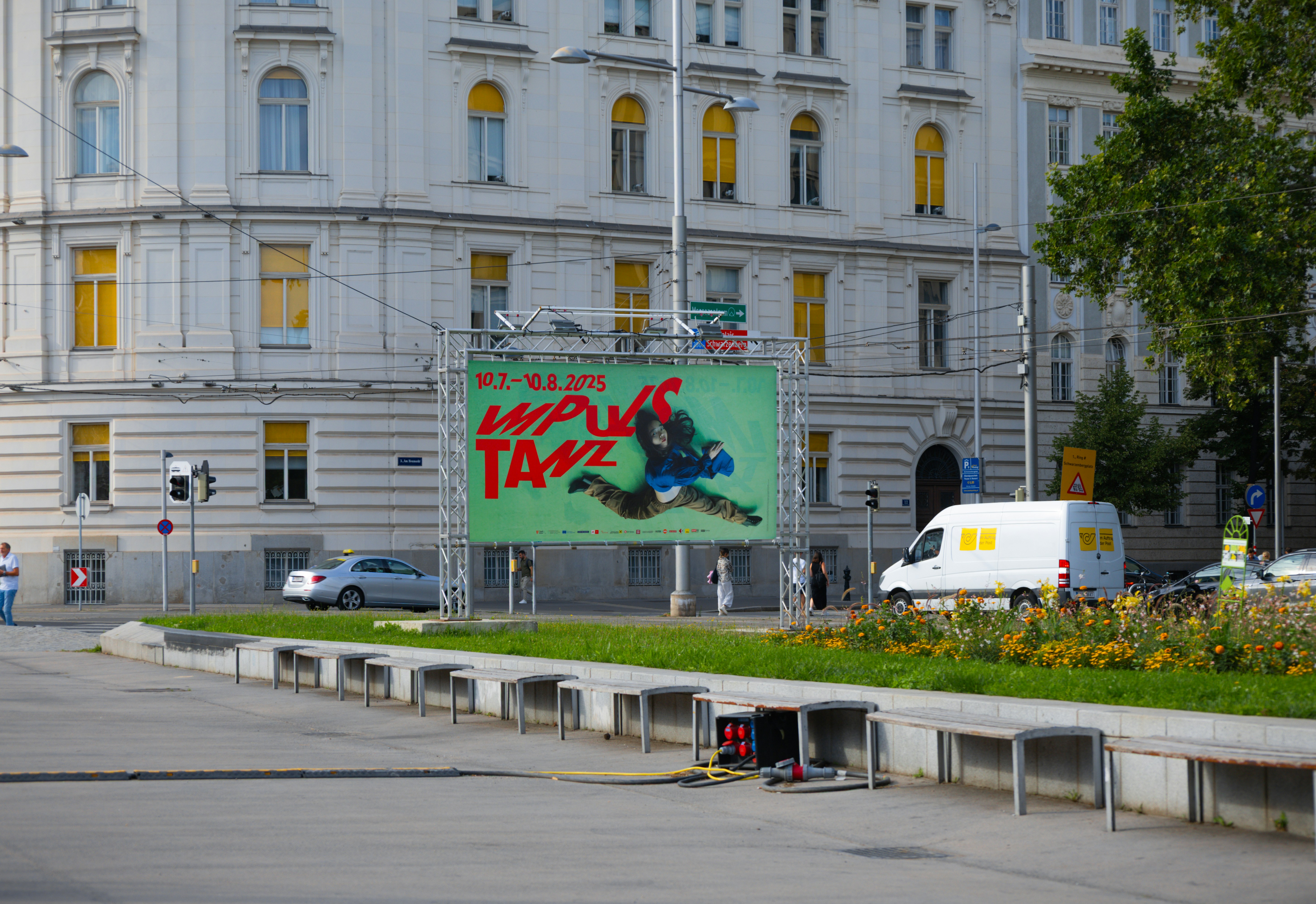 A taxi advertisement is displayed in front of a building.