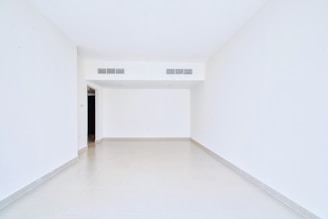 Empty, white room with open doorway.