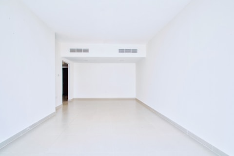 Empty, white room with open doorway.