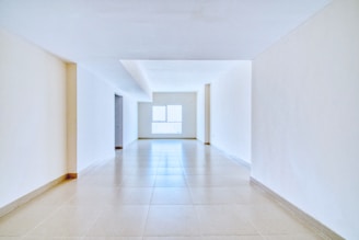 Empty hallway with natural light at the end.