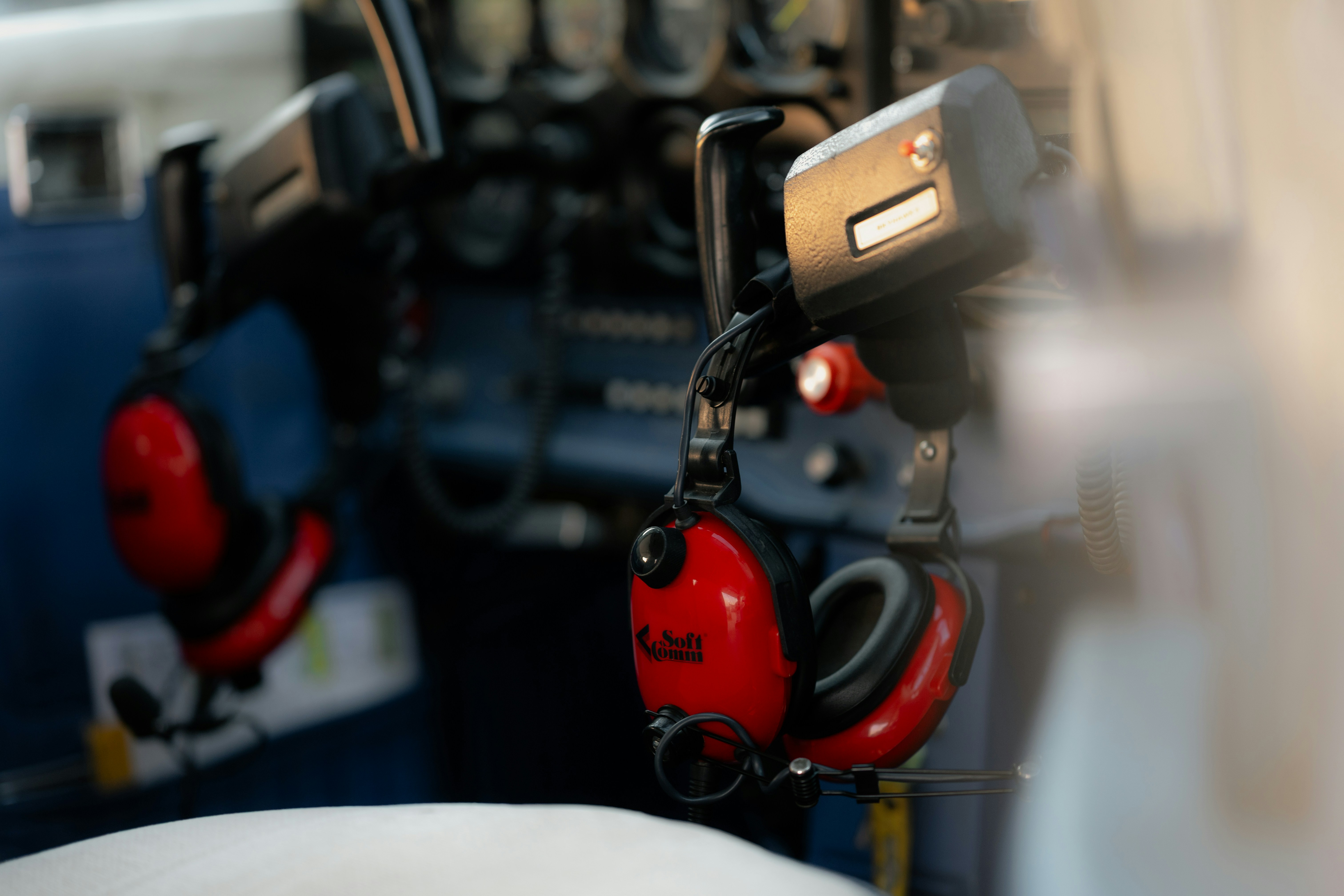 Headphones hanging inside an airplane cockpit.