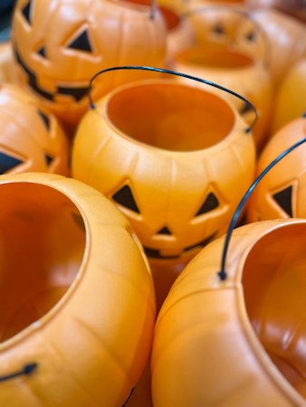 Rows of orange pumpkin candy buckets ready for Halloween, like the ones kids will carry along the Trunk or Treat trail at Black Mountain Recreation Center