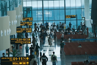 People walk through a crowded airport terminal.