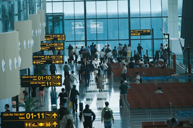 People walk through a crowded airport terminal.